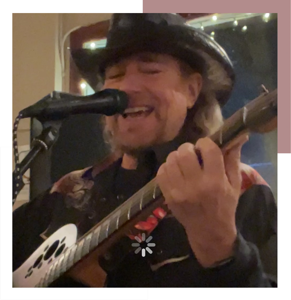 Musician passionately singing and playing guitar.