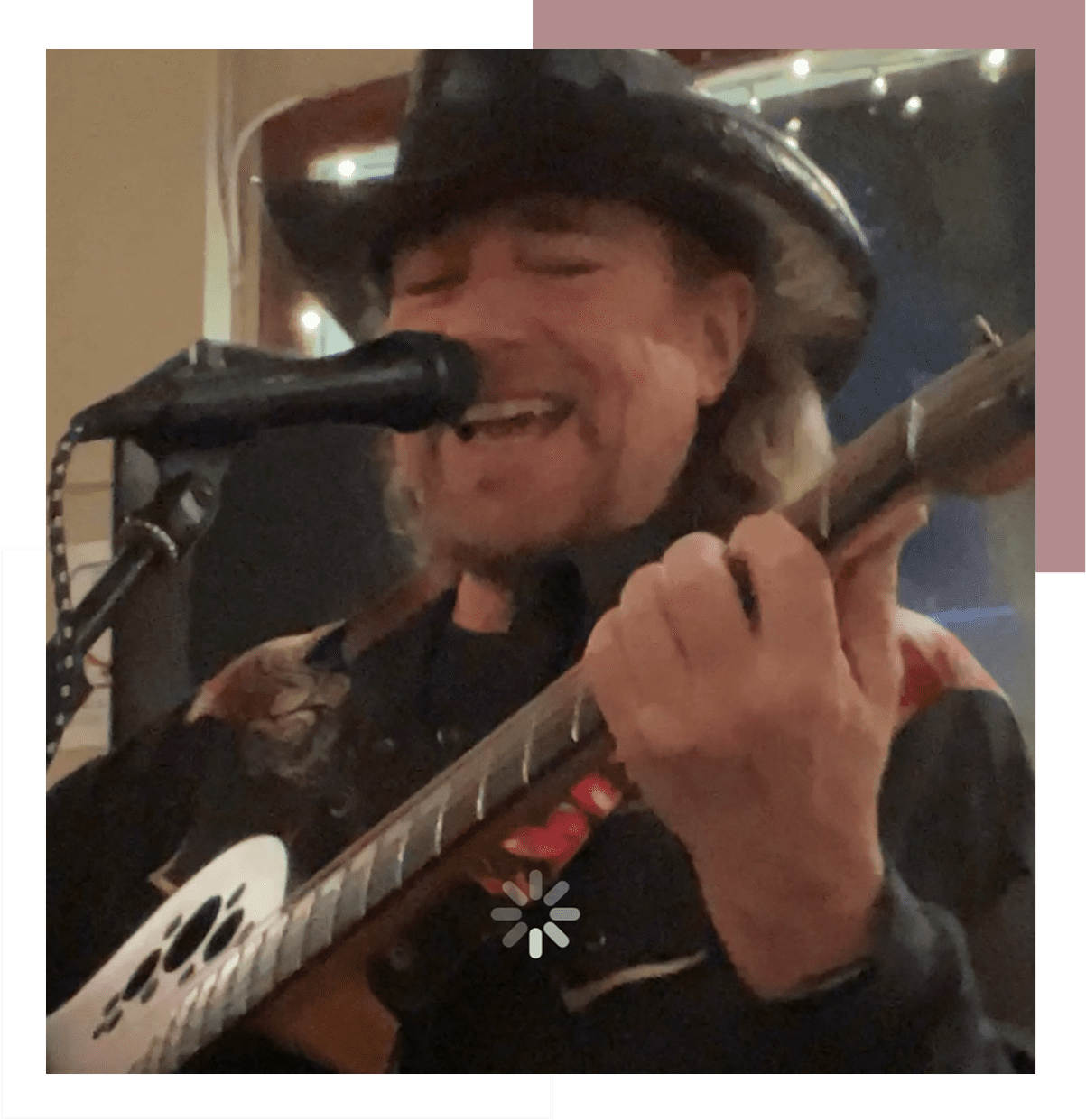 Musician passionately singing and playing guitar.